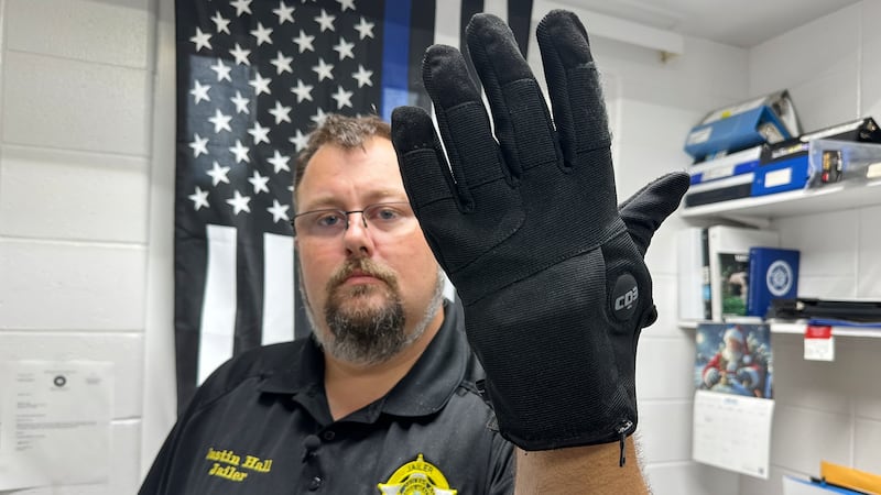 Nelson County, Ky., jailer Justin Hall shows an electric shock glove that is used at his...