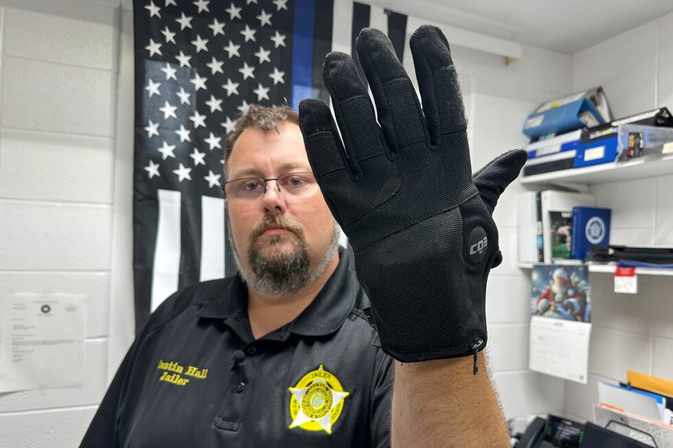 Nelson County, Ky., jailer Justin Hall shows an electric shock glove that is used at his...