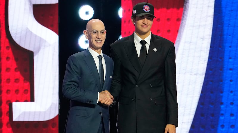 Karim Lopez, right, poses for a photo with NBA Commissioner Adam Silver, left, after being...