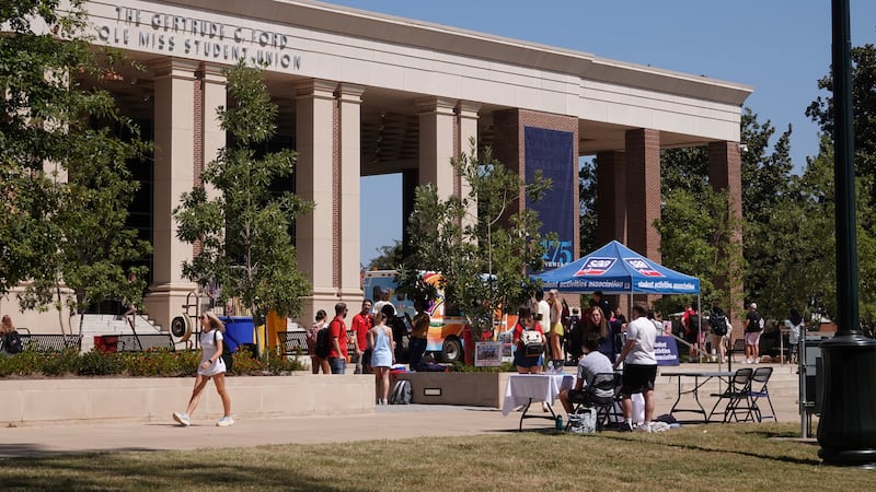 Students walk around the University of Mississippi campus in Oxford, Miss., Wednesday, Aug....